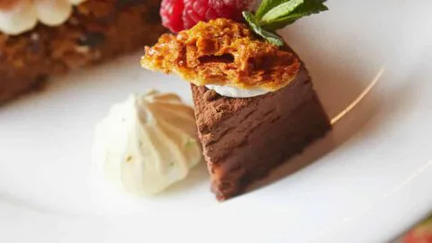 Indulge in a tiered platter of gourmet desserts with rich chocolate mousse, berry-topped cakes, and delicate pastries.