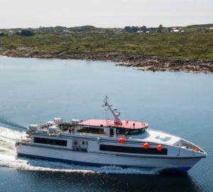 Guests enjoy a scenic ferry ride across calm waters with lush island views, adding adventure and relaxation to their stay.