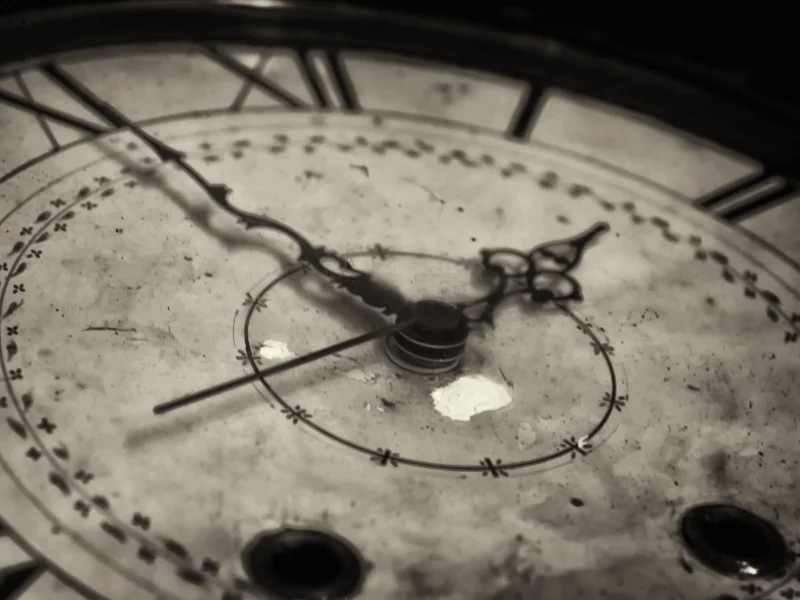 Close-up of an old, worn clock face with Roman numerals and ornate hands showing the time as 9:15.